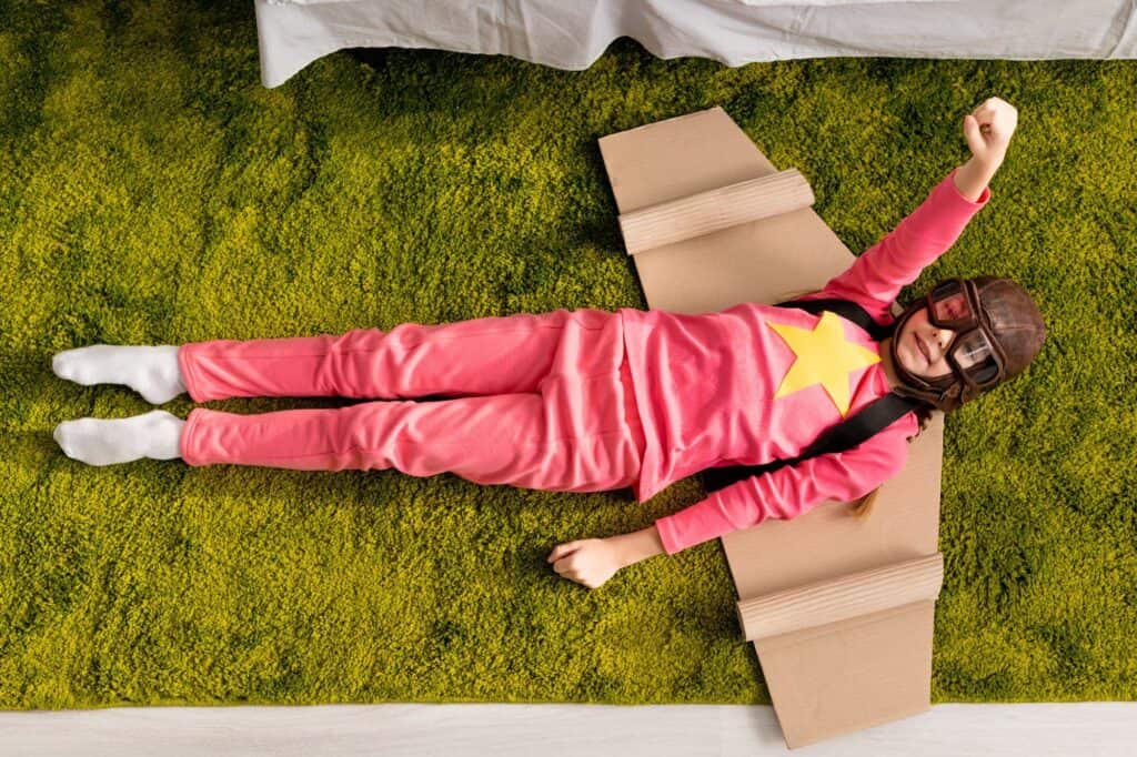 A kid playing with her DIY aircraft wings