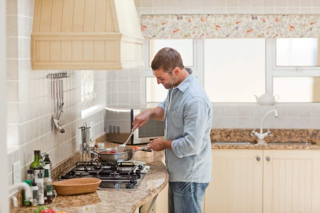 A man is cooking in the kitchen