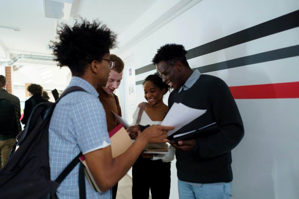 Smiling students talking in the school corridor